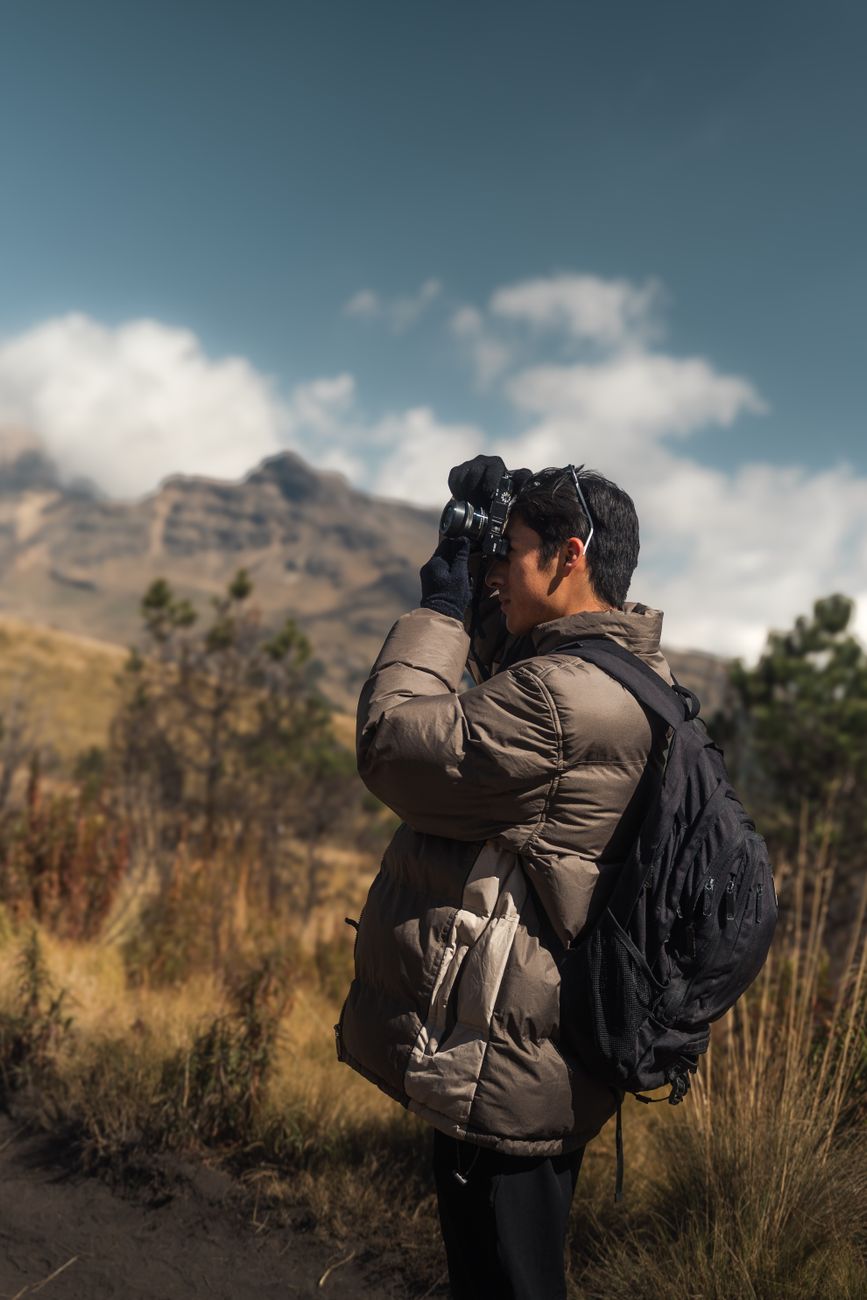 Travel photographer inspecting wilderness panorama